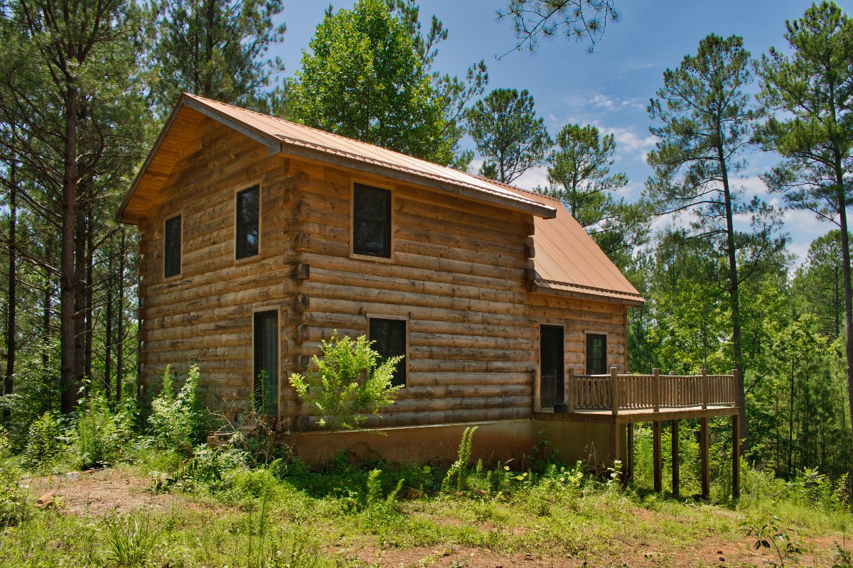 2.49 acres of wooded land with unfinished log cabin in Hearthstone Ridge